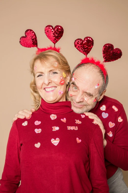 a man and woman posing for a picture with hearts on their heads, aging, antennae, warm, lynn skordal