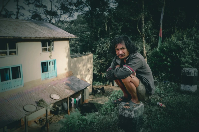 a man sitting on top of a tree stump, pexels contest winner, sumatraism, in front of the house, avatar image, destitute, portrait image
