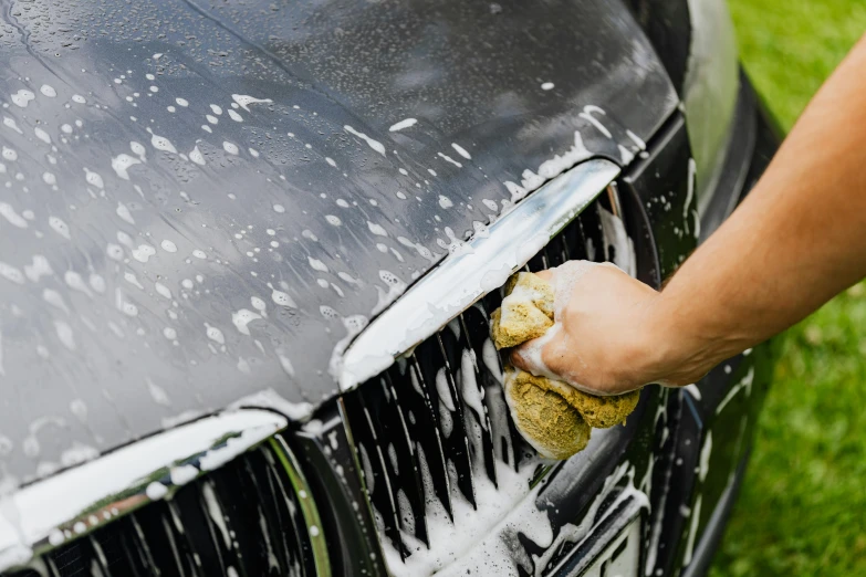 a person washing a car with a sponge, pexels contest winner, renaissance, in australia, fan favorite, more details, wet clay