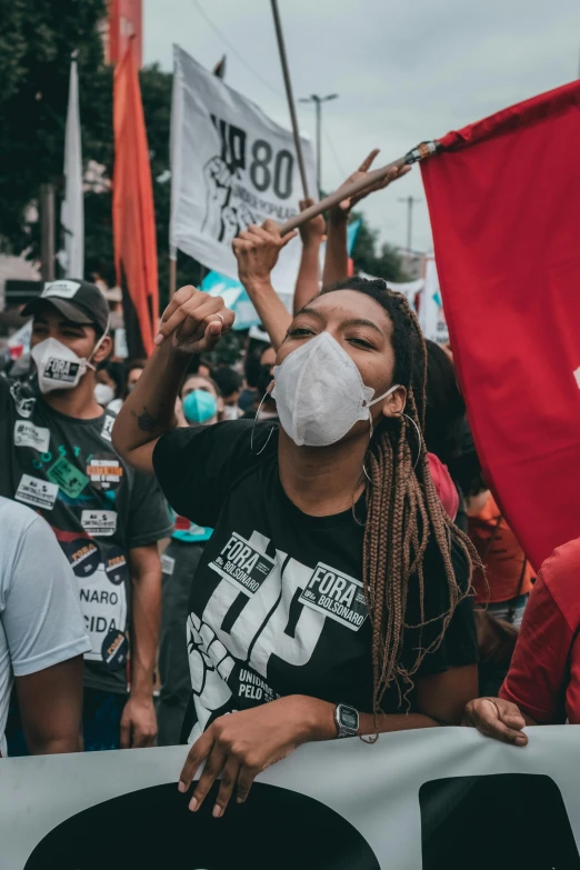 a group of people holding a red and white banner, a black and white photo, pexels contest winner, happening, face mask, philippines, smoke coming out of her mouth, future activist