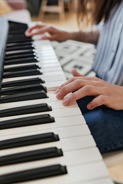 a close up of a person playing a piano, looking towards the camera