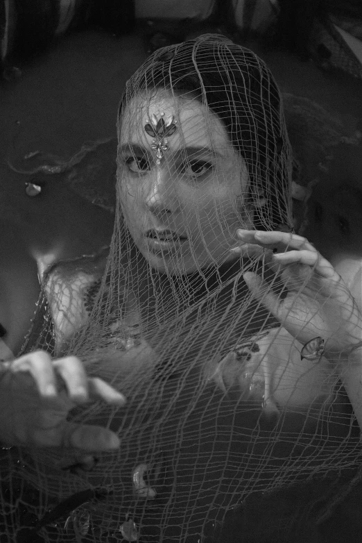 a black and white photo of a woman wearing a veil, inspired by Dora Maar, mahira khan as a d&d wizard, with cobwebs, shiva, square