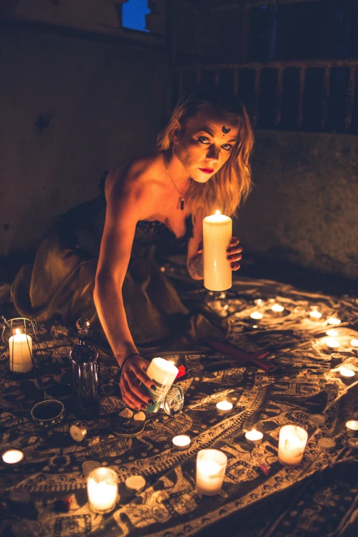 a woman sitting on a bed surrounded by candles, a portrait, trending on pexels, renaissance, hieroglyphic occult, in an ancient altar, female magician, photo of a model