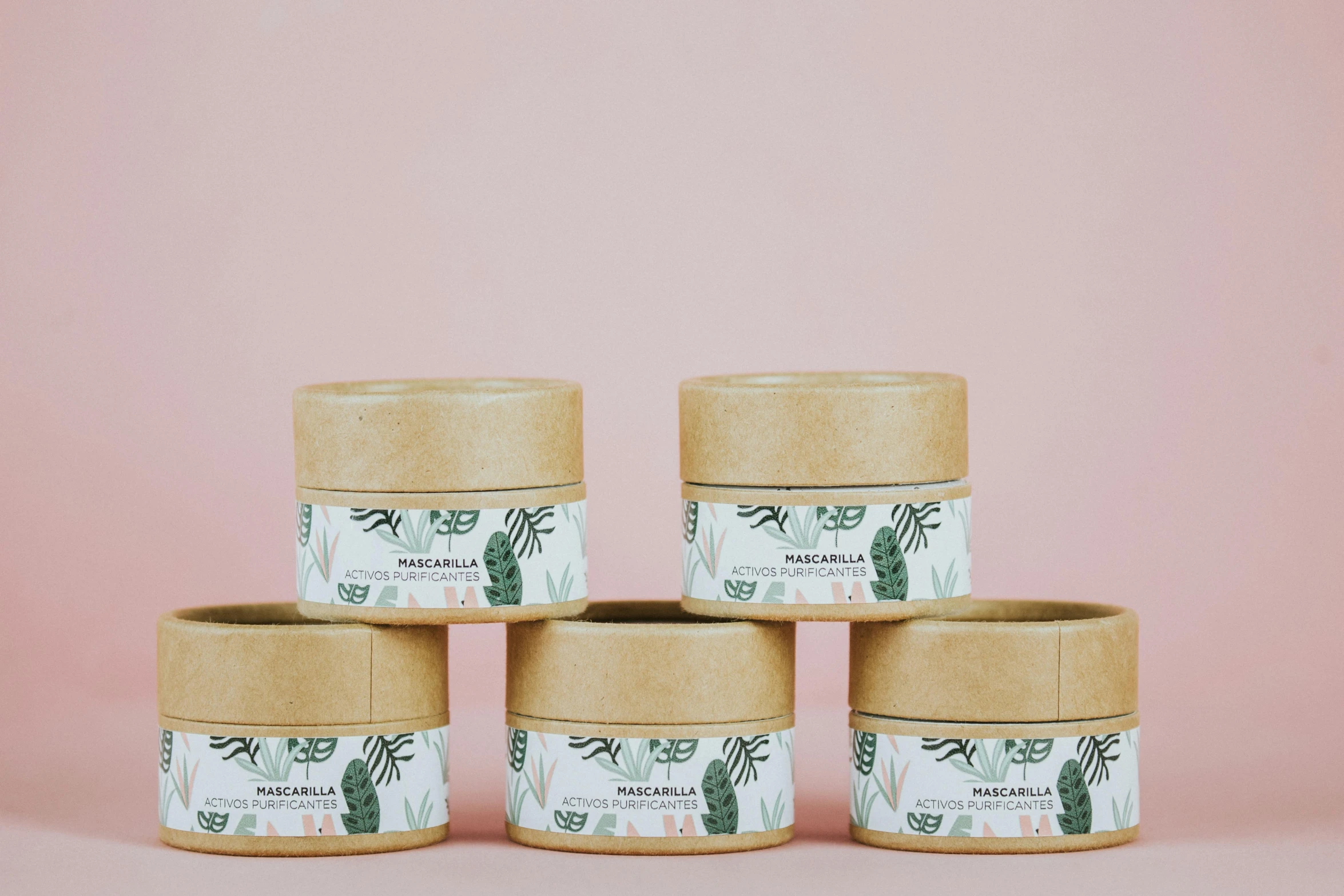 a stack of four jars sitting on top of a pink surface, product label, monstera, mini amphitheatre, 6 pack