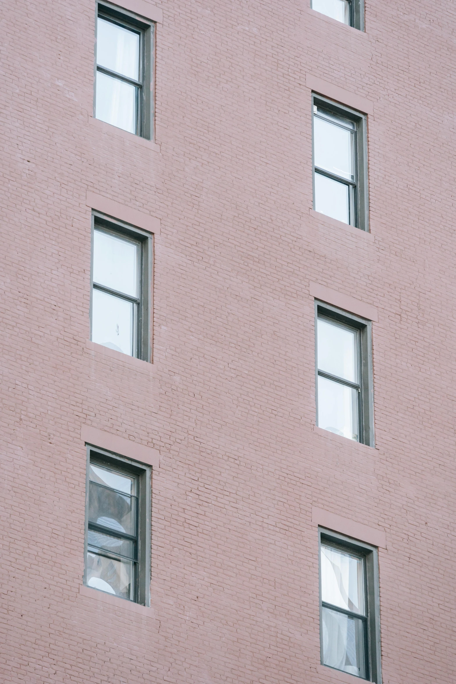 a traffic light on a pole in front of a building, a photo, inspired by Robert Bechtle, unsplash, postminimalism, pastel pink concrete, house windows, new york buildings, square face