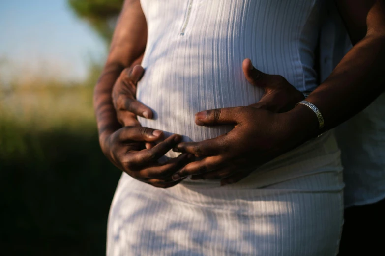 a close up of a person holding a cell phone, maternity feeling, entwined bodies, riyahd cassiem, hands crossed