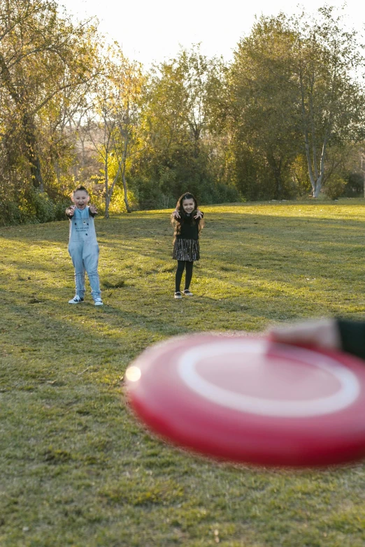 a group of people playing a game of frisbee, a picture, pexels contest winner, medium shot of two characters, kids, low ultrawide shot, 15081959 21121991 01012000 4k