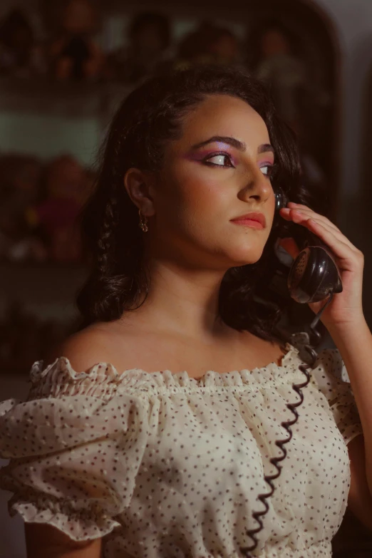 a woman holding a phone up to her ear, an album cover, inspired by Amelia Peláez, trending on pexels, renaissance, vintage makeup, betty la fea, production still, light skin