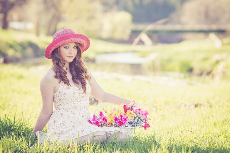 a woman sitting in the grass with a basket of flowers, wearing a cute hat, instagram photo shoot, avatar image, outdoor fine photography