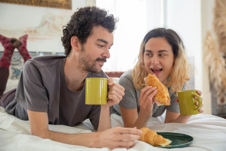 a man and a woman eating croissants on a bed, pexels contest winner, pizza the hut, woman drinking coffee, australian, eating garlic bread