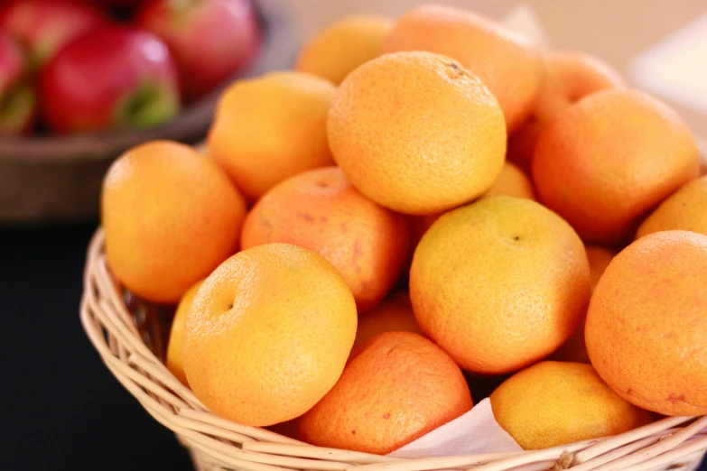 a basket of oranges sitting on top of a table, a stipple, pexels, mingei, close up of iwakura lain, (light orange mist), apple orange, full colour