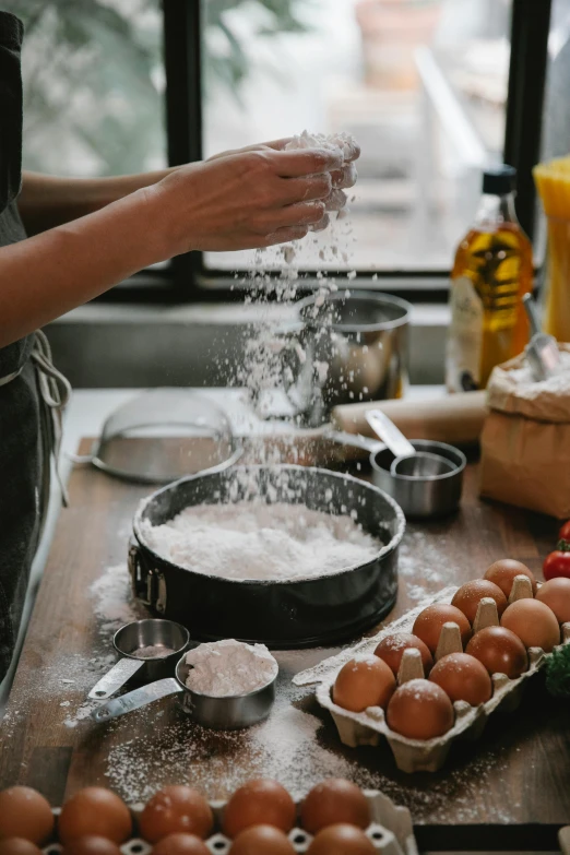 a woman sprinkles flour on eggs in a kitchen, a still life, trending on pexels, chefs table, paul barson, al fresco, 4l