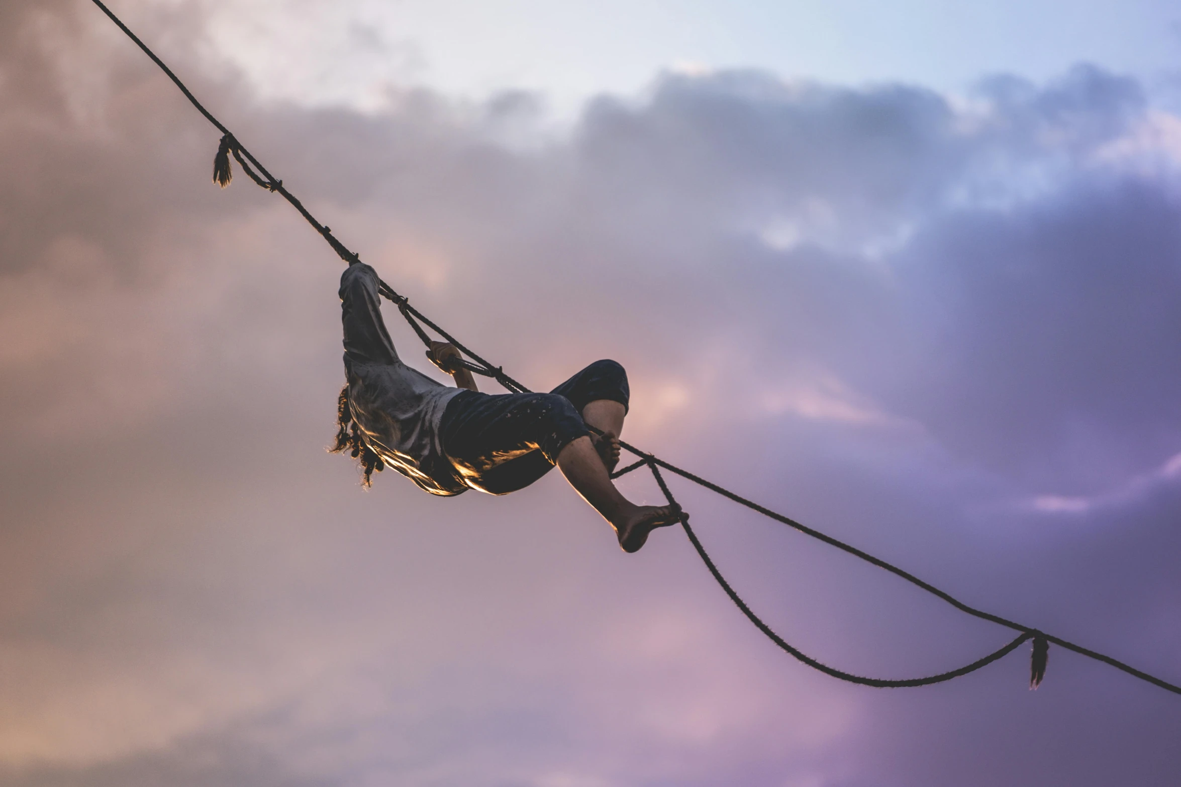 a person hanging upside down on a rope, by Lee Loughridge, pexels contest winner, arabesque, at dusk!, avatar image, high angle, profile image