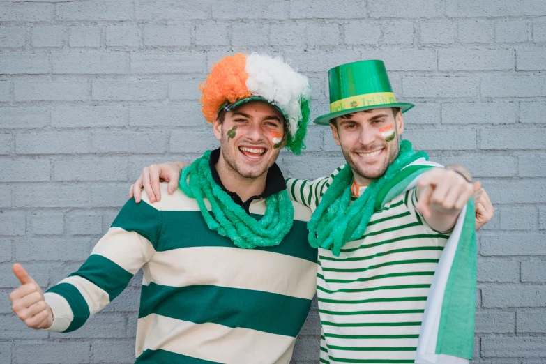 a couple of men standing next to each other, pexels contest winner, irish, fancy dress, striped, wearing green