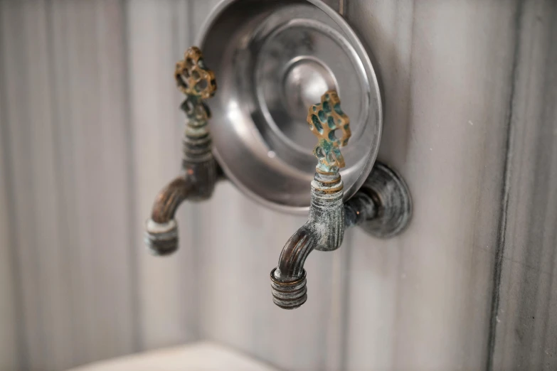 a close up of a faucet with water coming out of it, a bronze sculpture, inspired by George Henry, detailed no. 1 0 downing street, upcycled, rustic, grey