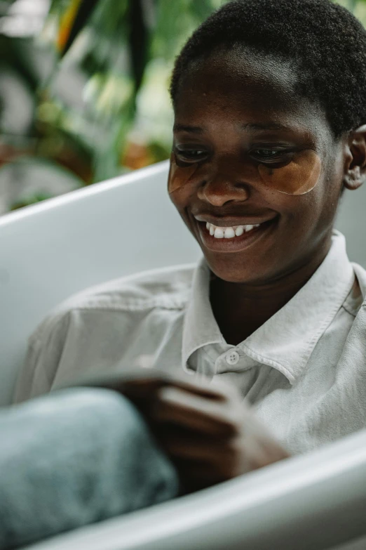 a woman smiles while sitting in a bathtub, by Daniel Lieske, trending on unsplash, afrofuturism, village girl reading a book, boy with neutral face, zoomed in, low quality photo