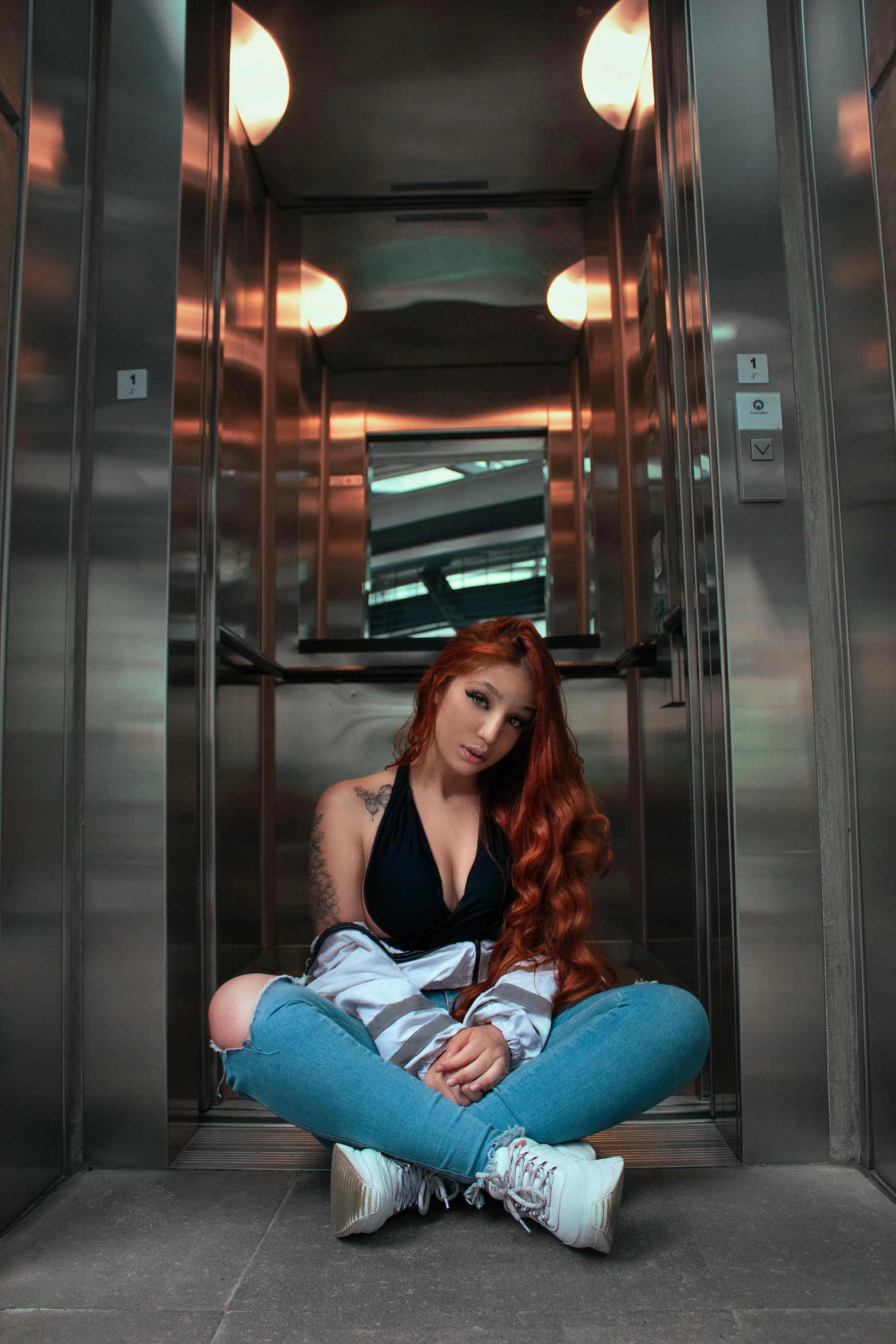 a woman sitting on the ground in an elevator, an album cover, inspired by Julia Pishtar, pexels contest winner, red hair girl, instagram model, leaked photo, lorena avarez