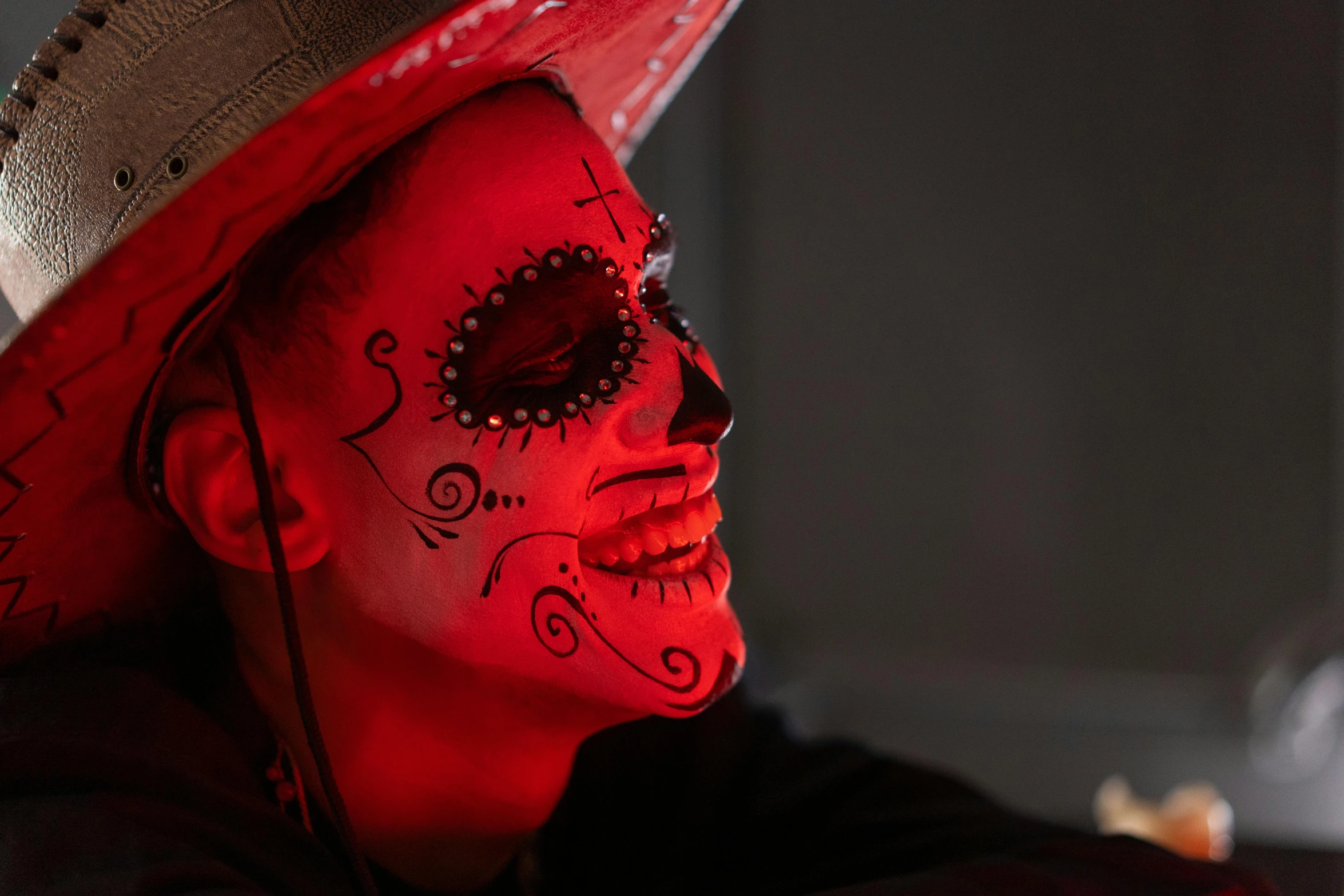 a close up of a person wearing a hat, a portrait, glowing red skull, la catrina, red leds, item