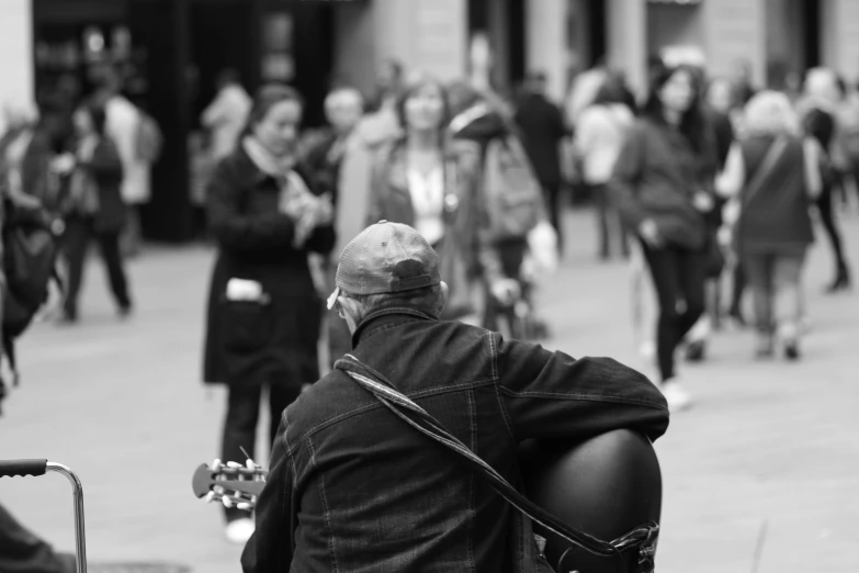 a black and white photo of a man with a guitar, by Robin Guthrie, pexels, people watching around, bald man, glasgow, a pilgrim