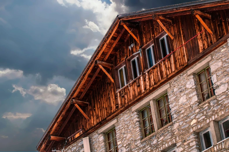 a building with a clock in front of a cloudy sky, by Franz Hegi, pexels contest winner, renaissance, rustic stone cabin in horizon, chalet, thumbnail, slide show