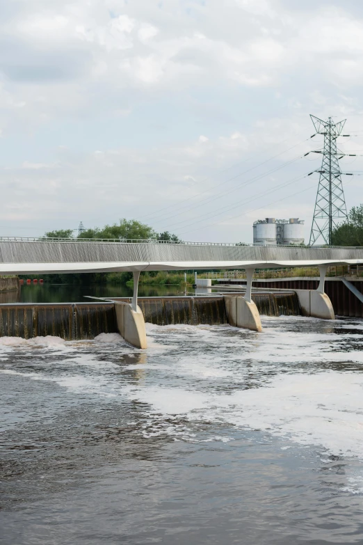 a large body of water with a bridge in the background, by Daarken, overflowing energy, sewage, thumbnail, hull