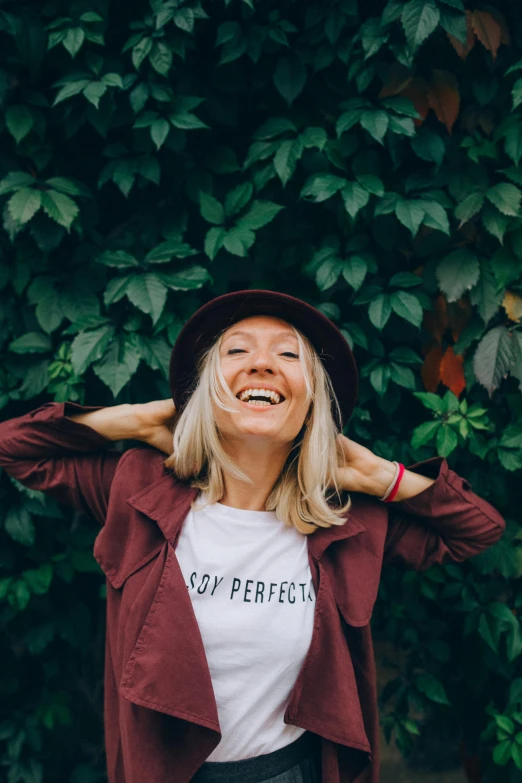 a woman wearing a t - shirt that says so perfect, pexels contest winner, antipodeans, with hat, full of joy, kirsi salonen, perfect symmetrical image