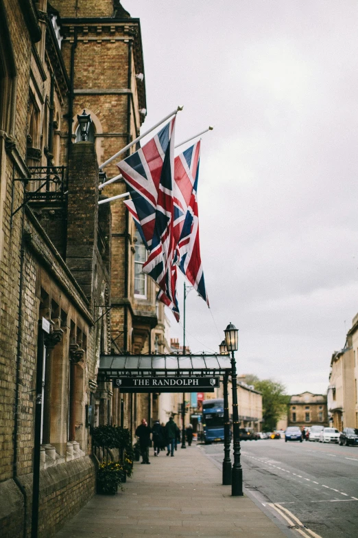 a british flag hanging from the side of a building, hotel, streetscapes, surrounding the city, bandoliers