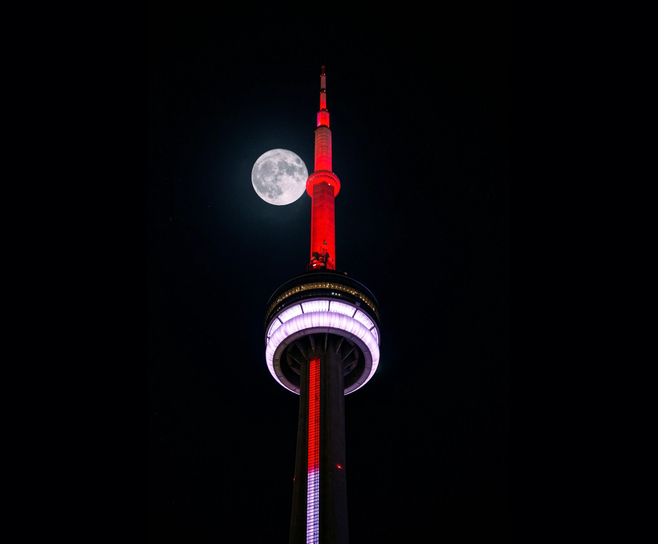 a tall tower with a full moon in the background, by Julia Pishtar, pexels contest winner, cn tower, red and white neon, award winning color photo, slide show