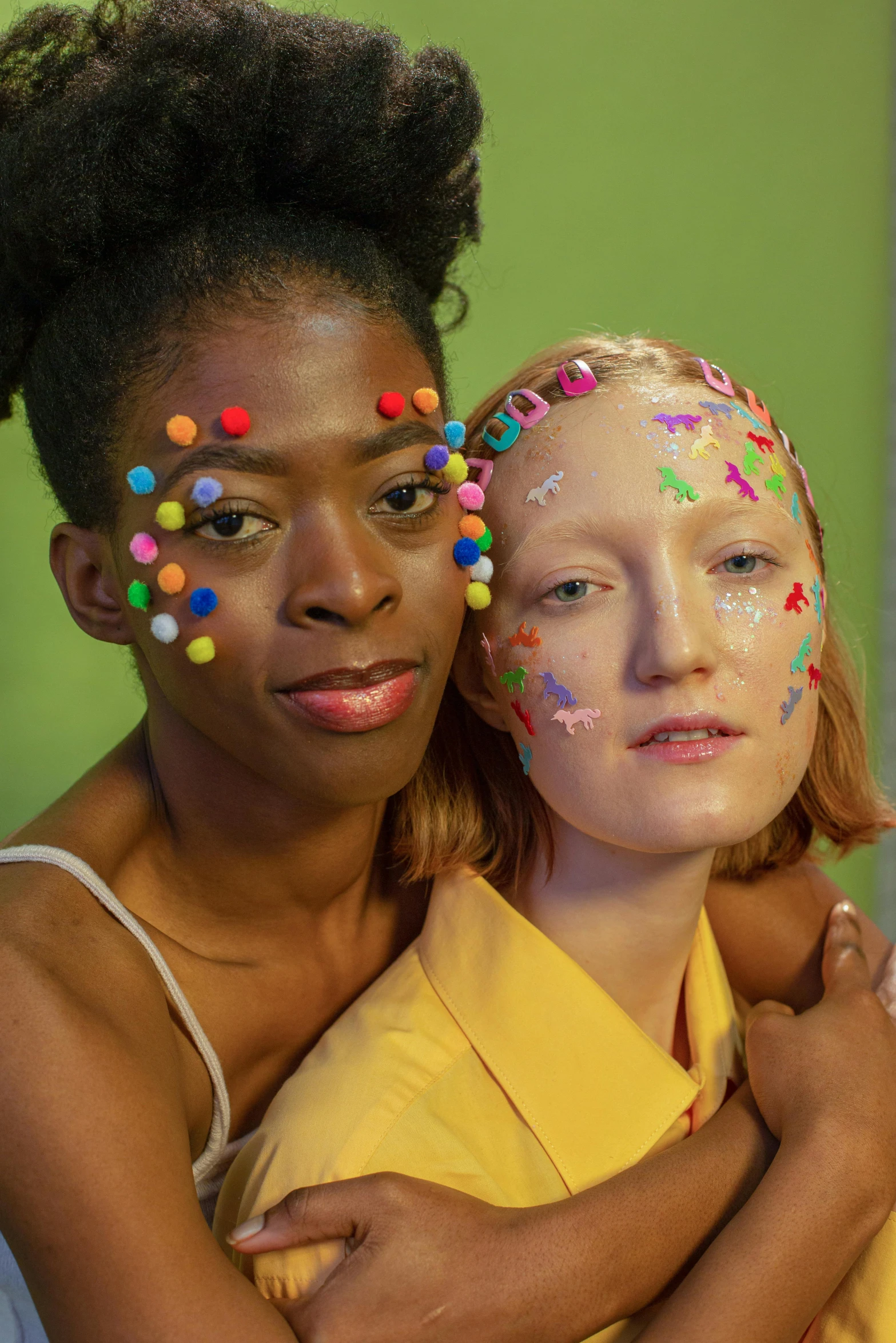 a woman hugging a young girl with sprinkles on her face, an album cover, by Lily Delissa Joseph, two models in the frame, colorful dots, ruan jia and mandy jurgens, showing forehead