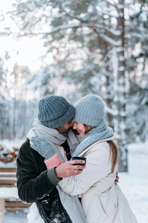 a man and woman standing next to each other in the snow, pexels contest winner, 🎀 🍓 🧚, phone, cozy setting, white