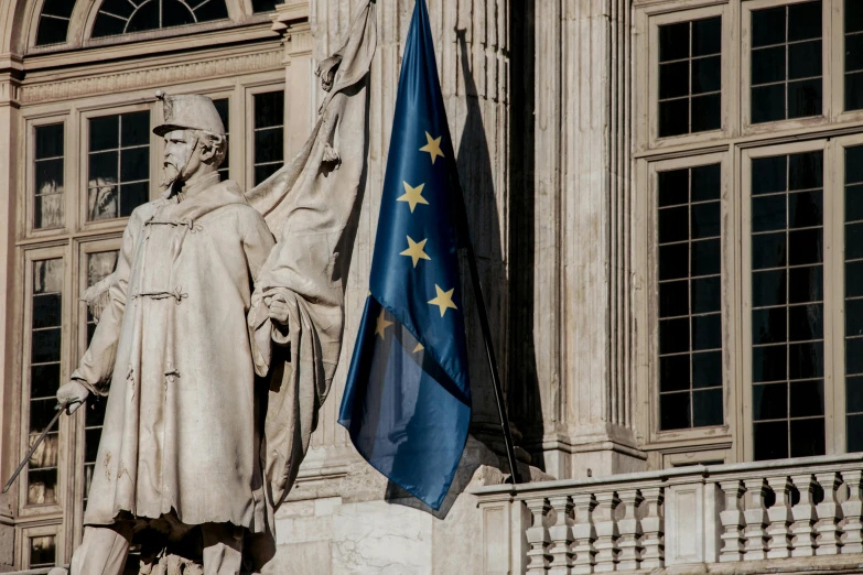 a statue of a man holding a flag in front of a building, a statue, by Daniel Seghers, pexels contest winner, renaissance, european union, executive industry banner, square, 🚿🗝📝