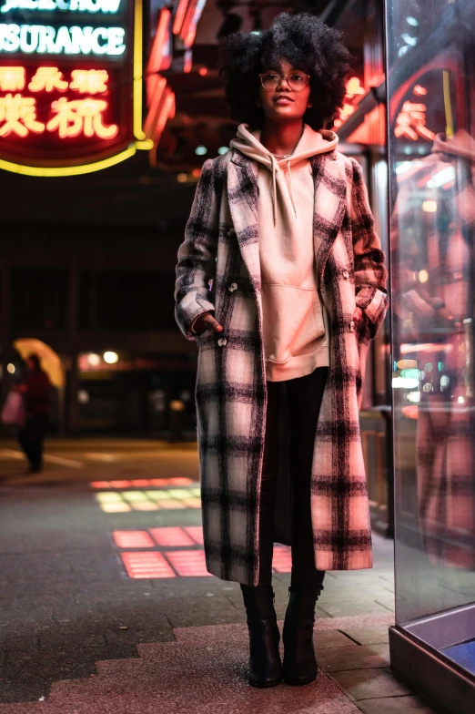 a woman standing in front of a store window, unsplash, graffiti, he wears a big coat, flannel, on rooftop tokyo night, trending on r/techwearclothing