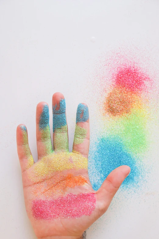 a child's hand covered in colored powder, a pointillism painting, inspired by Okuda Gensō, trending on pexels, glitter gif, ilustration, chalk, soft texture