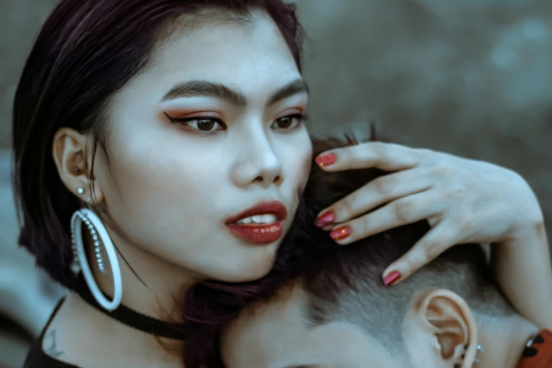 a couple of women standing next to each other, inspired by Elsa Bleda, trending on pexels, visual art, detailed face of a asian boy, thick red lips, undercut hairstyle, painted nails