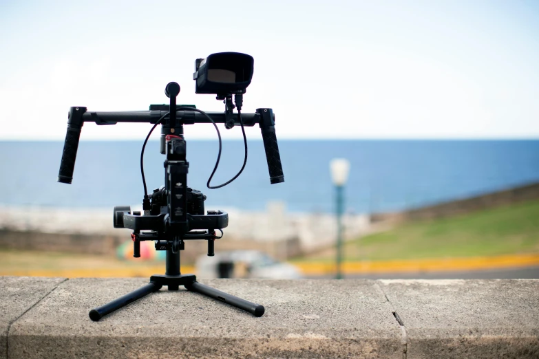 a close up of a camera on a tripod, unsplash, realism, graded with davinci resolve, standing near the beach, videogame still, cane