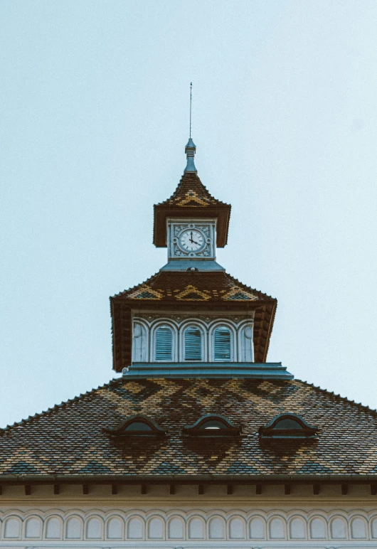 a clock tower on top of a building, inspired by Karl Stauffer-Bern, trending on unsplash, vancouver school, low quality photo, thatched roof, color image