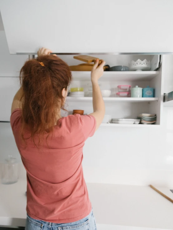 a woman that is standing in front of a refrigerator, holding a paintbrush, furniture, profile image, 2019 trending photo