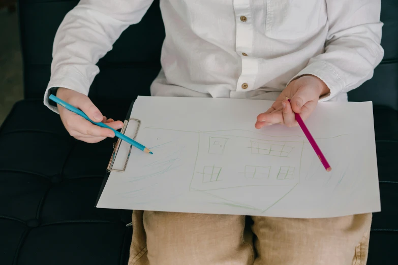 a person holding a pencil and drawing on a piece of paper, a child's drawing, holding a clipboard, without text, multiple stories, uploaded