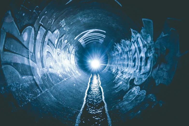 a tunnel with graffiti and a light at the end, an album cover, unsplash contest winner, blocked drains, blue light, thumbnail, navy