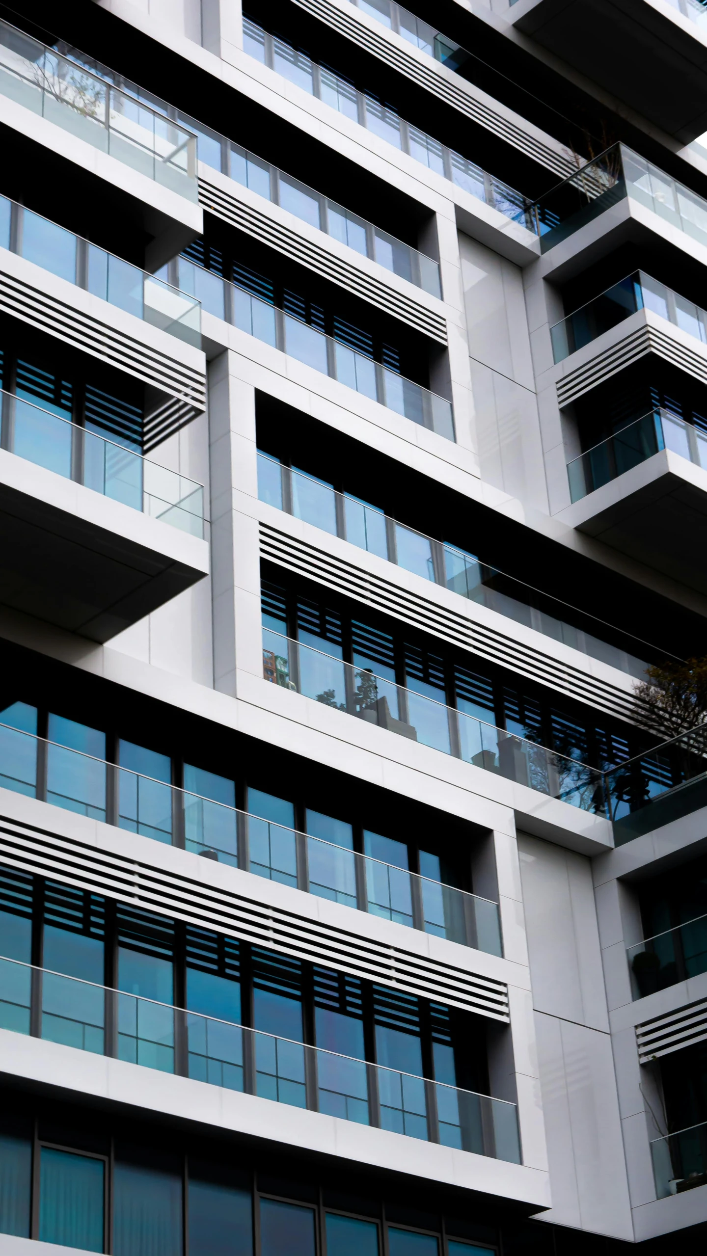 a tall building with lots of windows and balconies, flickr, concrete steel glass, high detail photo, square, ap news photo