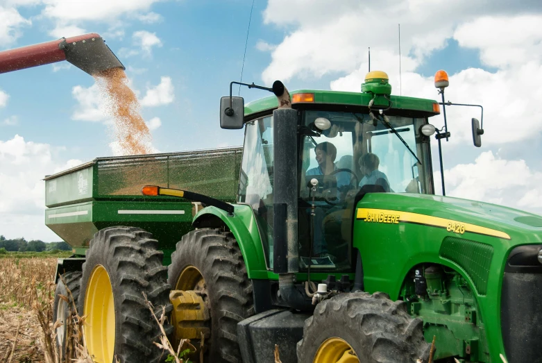 a tractor that is sitting in the dirt, by Joe Stefanelli, unsplash, corn, green gas spreading across land, avatar image, group photo