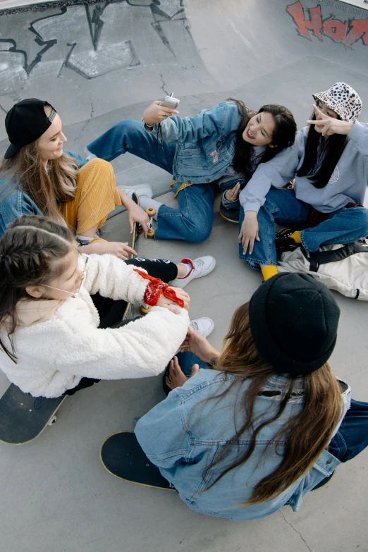 a group of people sitting on the ground with skateboards, in a circle, young girls, nika maisuradze, slide show