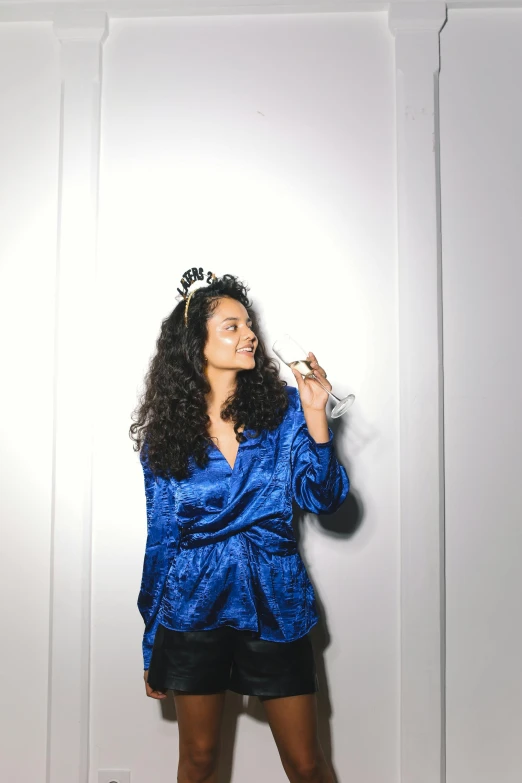 a woman in a blue shirt and black shorts, pexels contest winner, renaissance, tiara with sapphire, imaan hammam, new years eve, photo booth