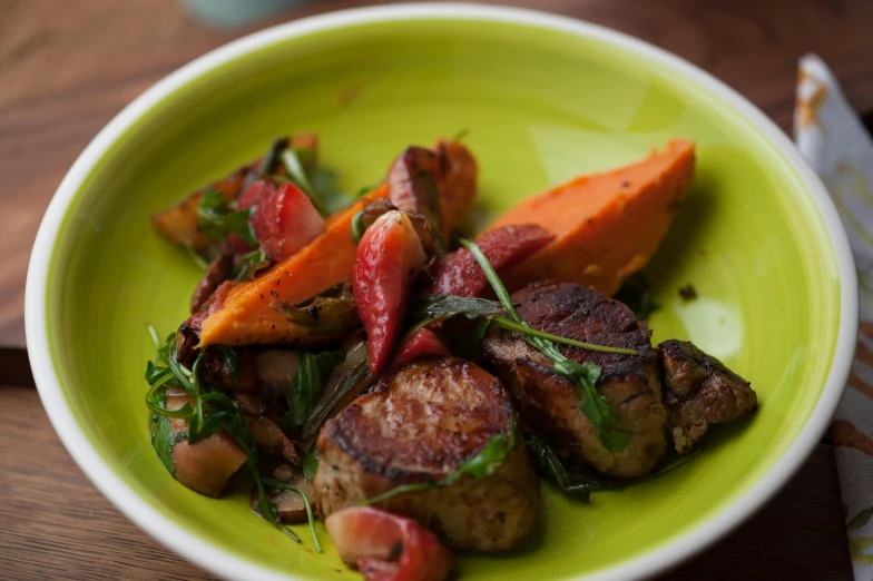 a close up of a plate of food on a table, by Alice Mason, ground red meat, teal orange, basil, round head