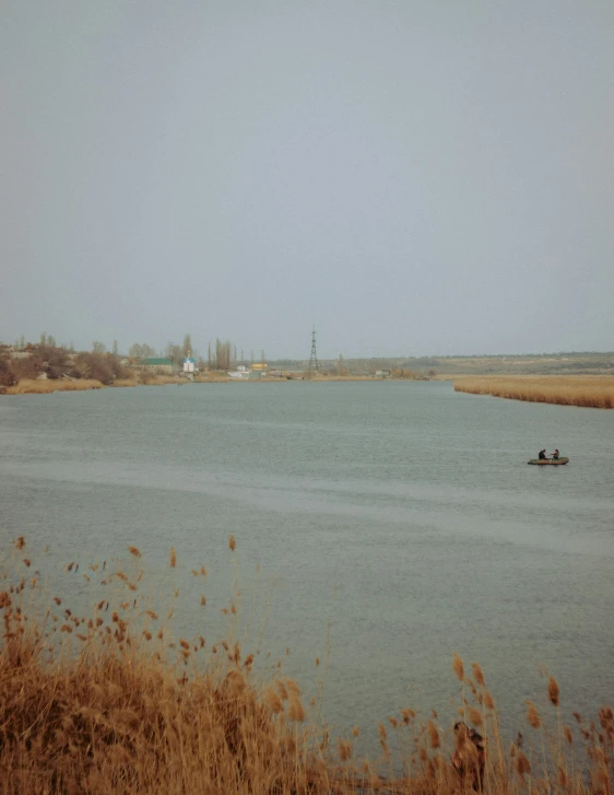 a couple of people in a boat on a body of water, a picture, by Attila Meszlenyi, phragmites, fishing town, photo on iphone, 000 — википедия