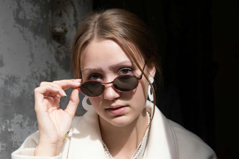 a close up of a person wearing sunglasses, inspired by Henriette Grindat, thin round earrings, anna podedworna, maroon accents, yulia nevskaya