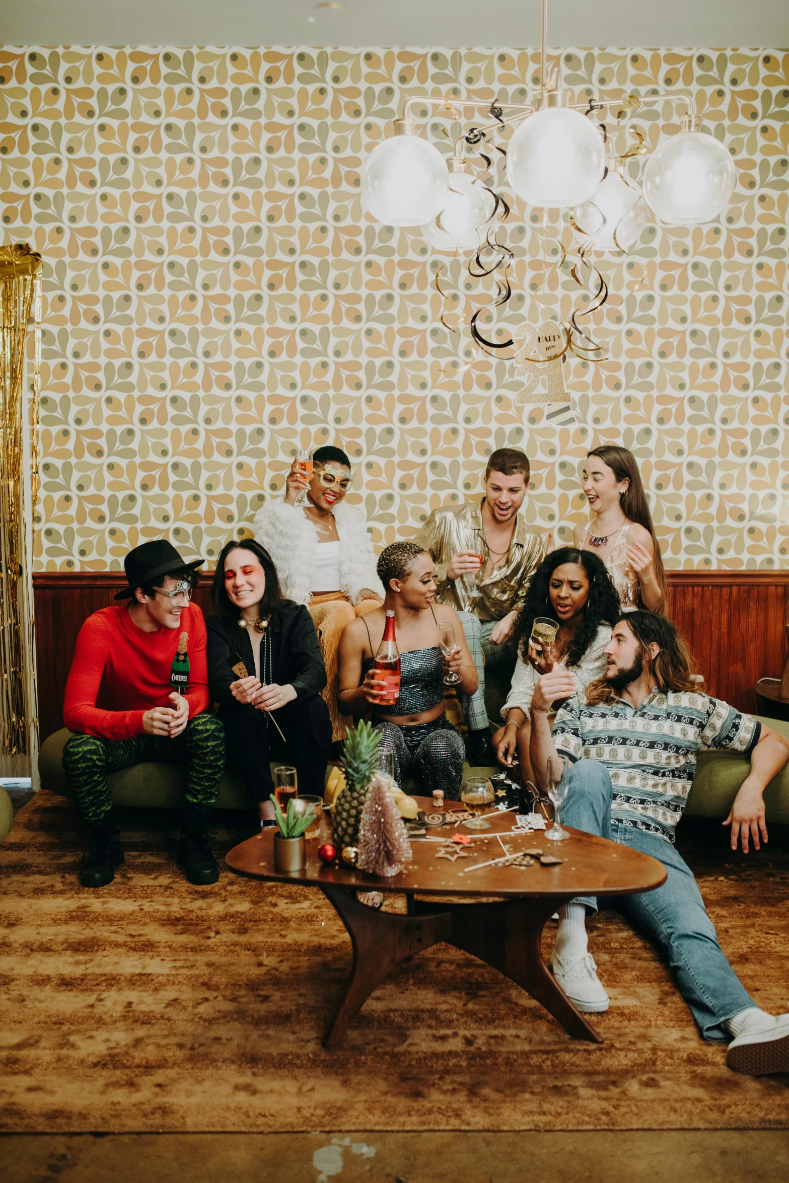 a group of people sitting in a living room, an album cover, by Sara Saftleven, trending on pexels, renaissance, milk bar magazine, many partygoers, group portrait, long table