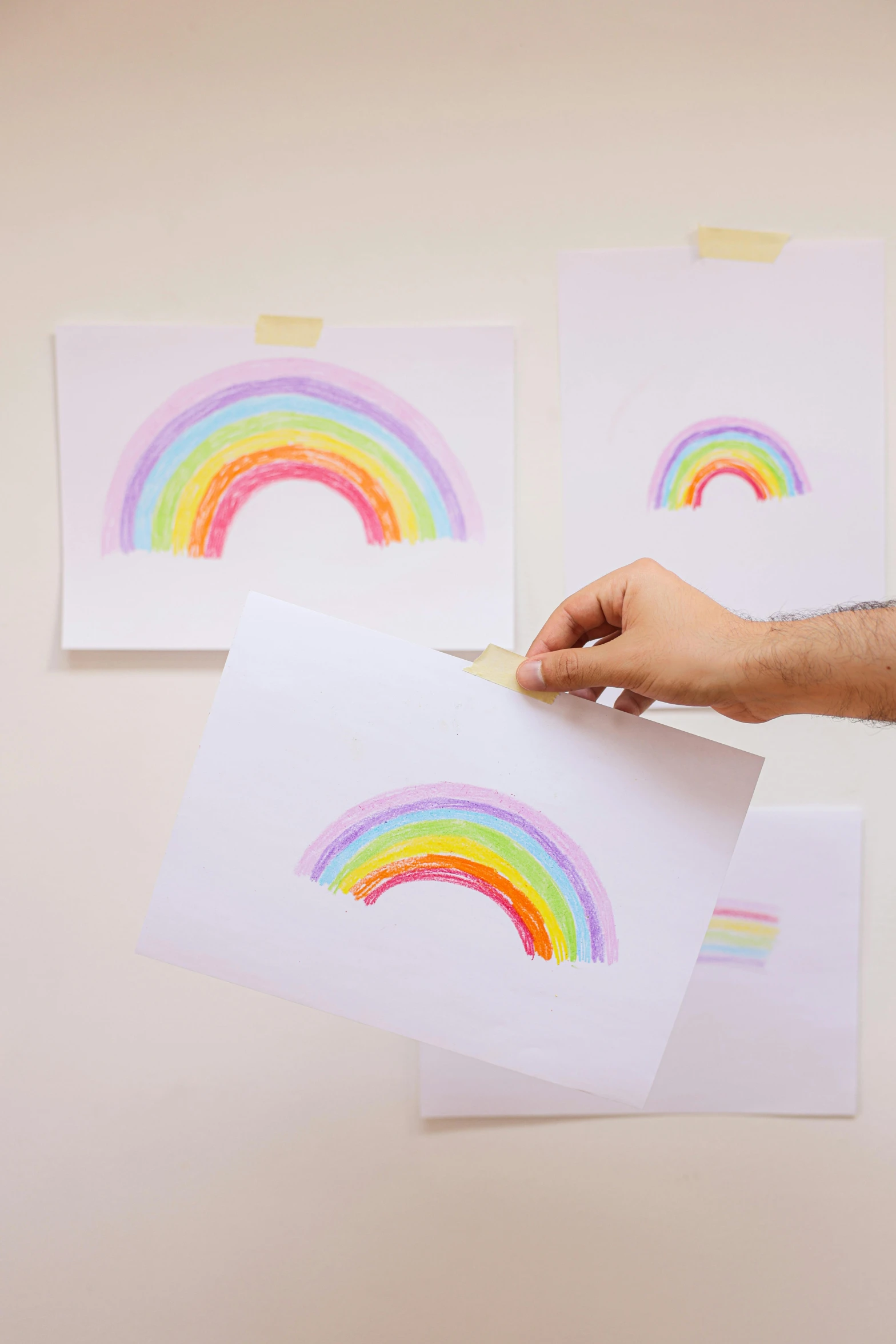 a person holding a piece of paper with a rainbow drawn on it, crayon art, wall full of small art painting, promo image, ffffound, art set