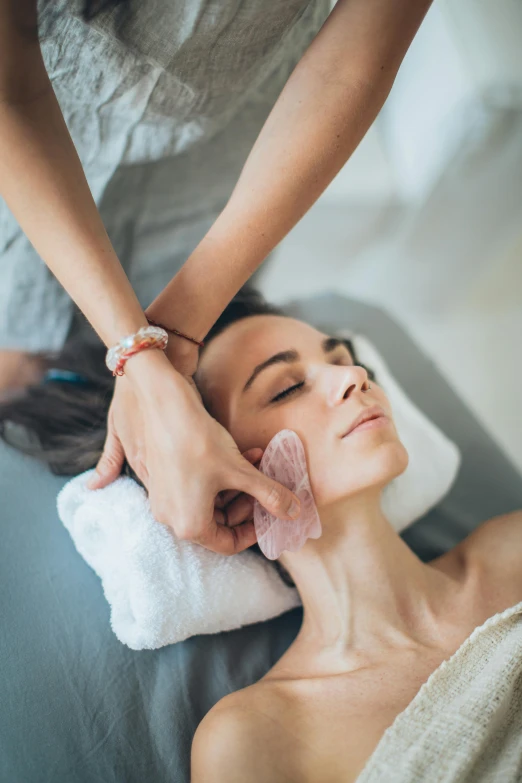 a woman getting a facial massage at a spa, by Adam Marczyński, made of lab tissue, square, grey, crystal