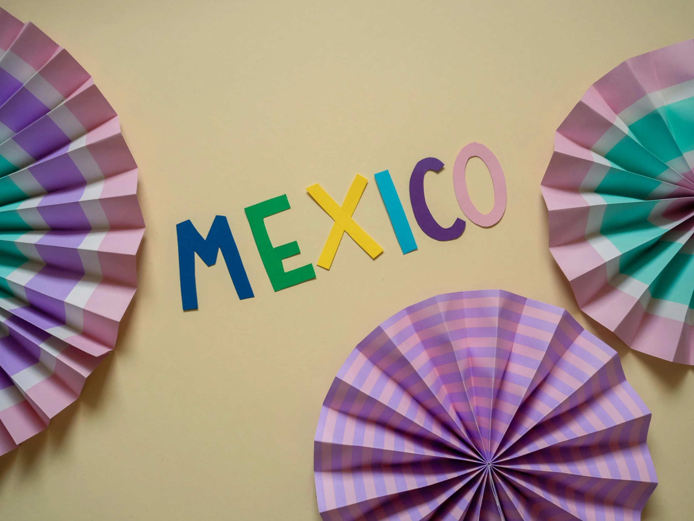 a group of paper fans sitting on top of a wall, by Rachel Reckitt, she is mexican, lettering, purple colour scheme, flags